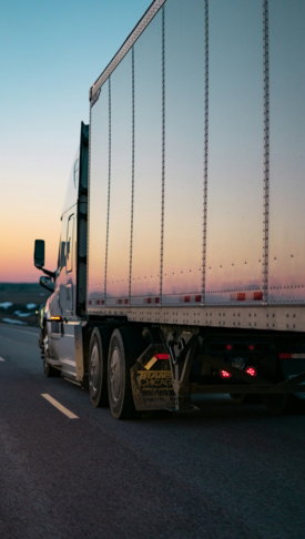 white freight truck on road during daytime
