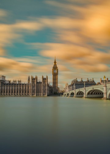 brown tower clock under cloudy sy
