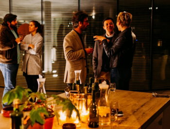 five person standing while talking each other